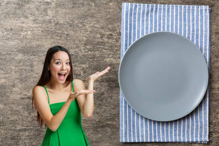 donna entusiasta che indica una tovaglietta di stoffa con un piatto sopra
